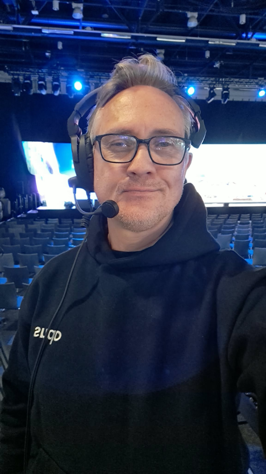 A camera operator in an intercom headset on the Dell Technologies Forum floor